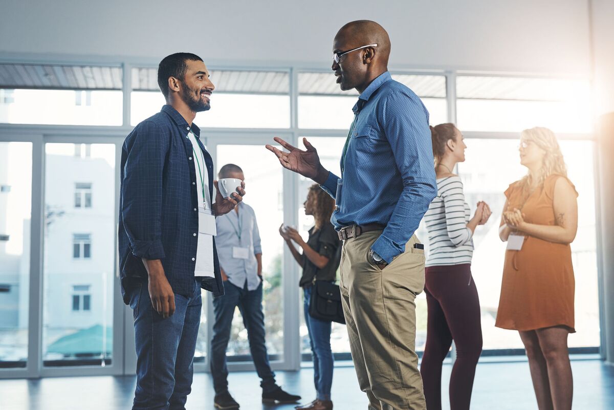 Two advisers in conversation at a networking event