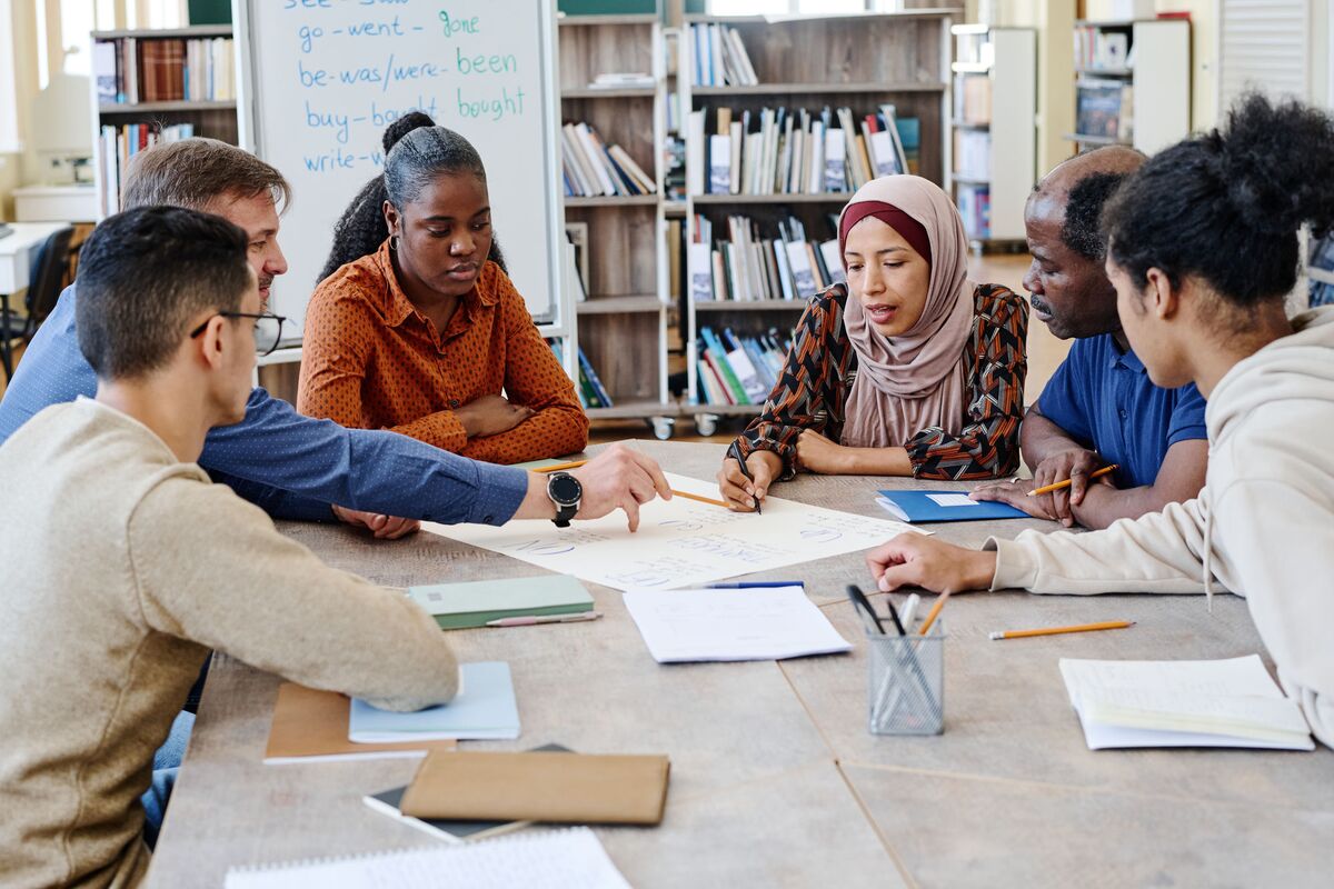 A group working through notes together around a library table